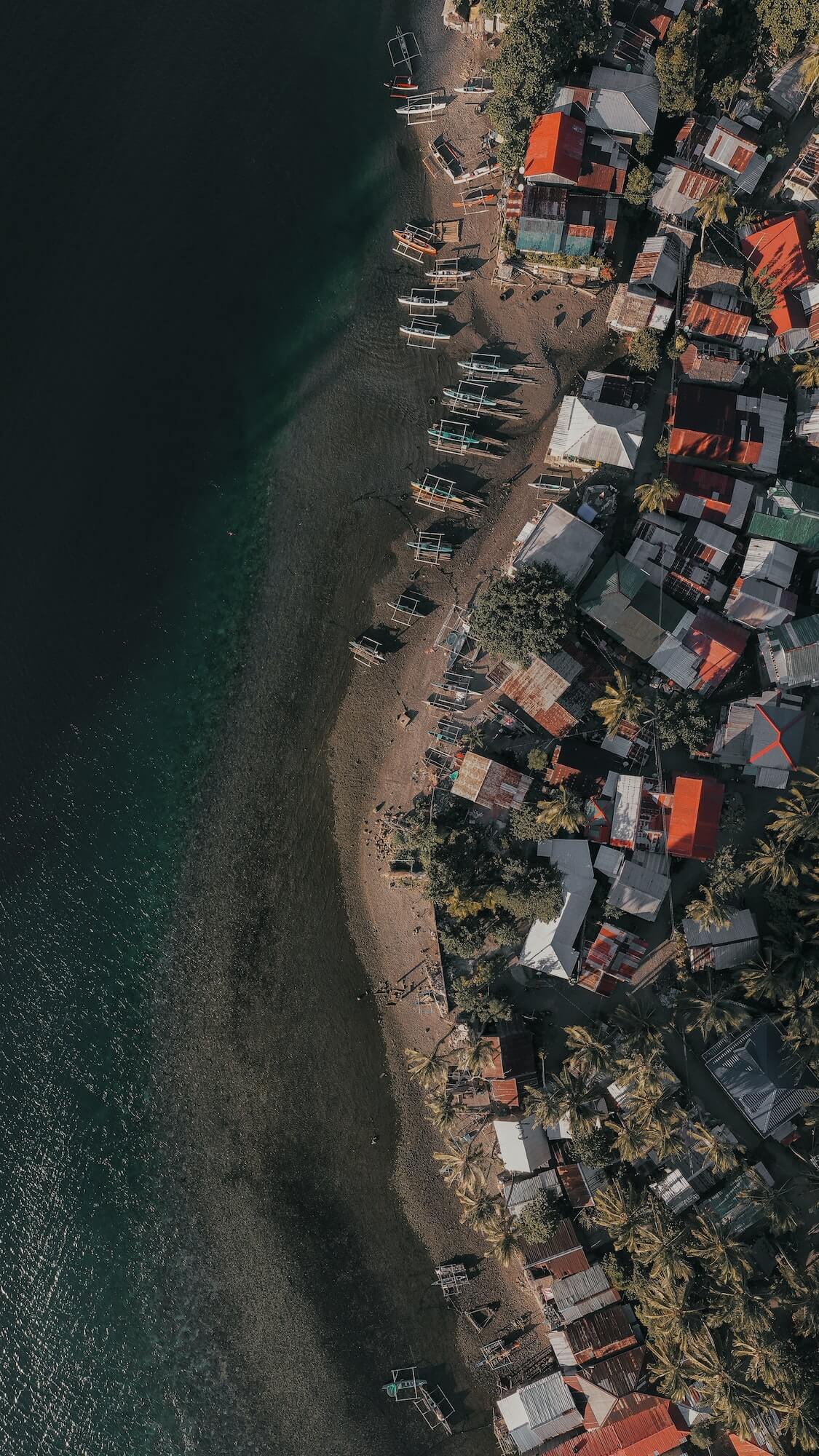 aerial shot of a small fishing village in a countryside island in the philippines